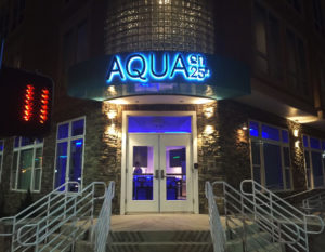 Aqua front sign at night